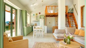 a living room with a couch and a table at Alkyoni luxury apartments Katakolo in Katakolon