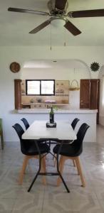 a table and chairs in a kitchen with a ceiling fan at El Sol del Cuyo in El Cuyo