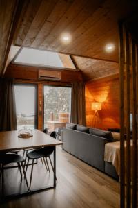 a room with a bed and a table and chairs at Casas da Madrinha in Arcos de Valdevez