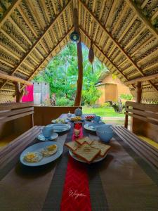 a table with plates of food on top at Maika safari lodge in Udawalawe