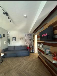 a living room with a couch and a flat screen tv at Sweet Home in Klagenfurt