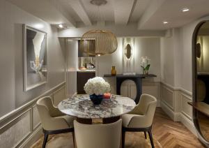 a dining room with a table and chairs and a fireplace at Mandarin Oriental Savoy, Zurich in Zurich
