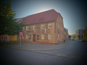 a large brick building on the corner of a street at Gasthaus Wolfsschlucht in Herzberg