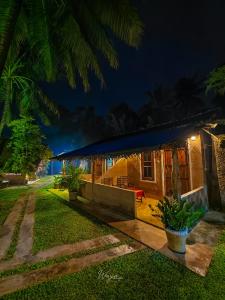 a house with a blue roof at night at Maika safari lodge in Udawalawe