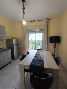 Una cocina y un comedor con mesa y sillas. en Sicily Etna Mareneve Taormina, en Fiumefreddo di Sicilia