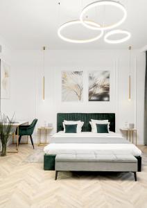 a bedroom with a large bed and a chandelier at Villa for rent with Garden - High Ceilings Bucharest Free Park in Bucharest