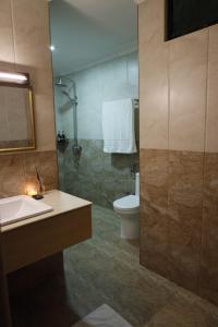 a bathroom with a sink and a toilet at Samaik Thulusdhoo in Thulusdhoo +18 photos