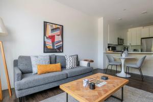 a living room with a couch and a table at Blueground Newtonville rooftop nr Newton Centre BOS-1233 in Newton