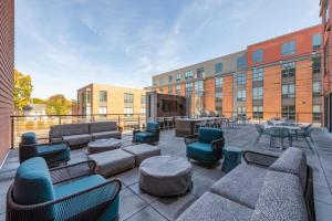a patio with couches and chairs and a table at Blueground Newtonville rooftop nr Newton Centre BOS-1233 in Newton
