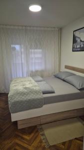 Ένα ή περισσότερα κρεβάτια σε δωμάτιο στο Apartman Danica