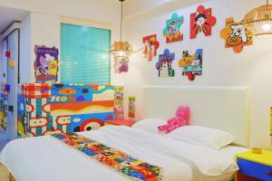 a bedroom with a white bed and some pictures on the wall at Youshine Service Apart-ment ---English Speaking in Chengdu
