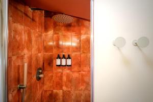 a bathroom with bottles of wine on the wall at Hotel Boutique CaLagneta - Art i Vi in Cervera