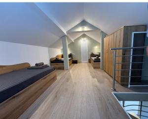 a bedroom with a bed and a staircase at Guest house LORA in Gabrovo