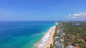 an aerial view of a beach and the ocean at Lavinia Beach Hotel Ambalangoda in Ambalangoda