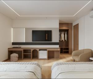 a living room with two beds and a flat screen tv at Lam Anh Hotel 9 Him Lam Vạn Phúc in Hà Ðông