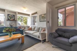 a living room with two couches and a table at Casa Rosa in Querétaro