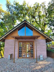 a small house with a large glass door at Cabana liberdade 2 in Rio dos Cedros