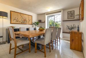 a dining room with a wooden table and chairs at Casa Rosa in Querétaro