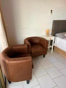a room with a chair and a chair and a bed at Olimpia Sunset Studio in Costa de Adeje