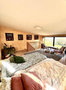 a bedroom with a bed and a table and chairs at Nastawka Cottage Creativity and Regeneration in Raciechowice