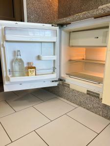 an open refrigerator with a bottle of alcohol in it at Olimpia Sunset Studio in Costa de Adeje