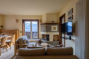 a living room with a couch and a fireplace at Oga View Apartment in Oga