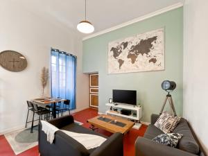 een woonkamer met een bank en een tafel bij Duplex - Place du Parlement de Bretagne - Hyper Centre de Rennes in Rennes +17 foto's