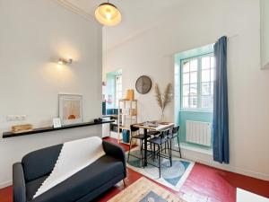 een woonkamer met een bank en een tafel bij Duplex - Place du Parlement de Bretagne - Hyper Centre de Rennes in Rennes
