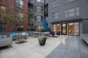 a courtyard in a building with tables and chairs at Blueground Bethesda fitness center nr Cabin John Park WDC-571 in Bethesda