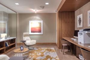 a office with a desk and a chair and a table at Blueground Bethesda fitness center nr Cabin John Park WDC-571 in Bethesda