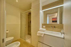 a bathroom with a shower and a toilet and a sink at La Corte Delle Dolomiti in Agordo +18 photos