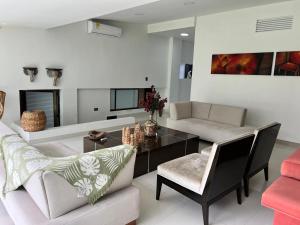 Casa de lujo en Cali con Piscina Privada y BBQ في كالي: غرفة معيشة بها أريكة وطاولة