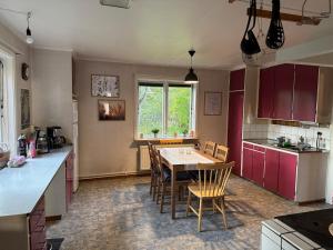 a kitchen with a table and chairs in a room at Holiday home Hönstorp in Hagfors