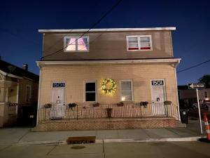 a house with a christmas wreath on the window at 2 Bedroom 2 Bath Fun Vibes NO PET FEES in New Orleans