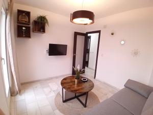 een woonkamer met een bank en een tafel bij Amanecer Andaluz in Ronda