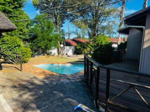 a backyard with a swimming pool next to a house at Sagrada Guest House in Mthatha
