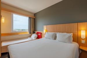 Postel nebo postele na pokoji v ubytování Transamerica Fit Aracruz