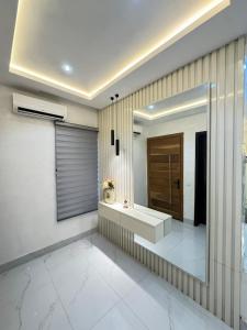 a bathroom with a sink and a mirror at Dazzling Lekki 3BR Home - Private Balcony - 247 Power, Wifi & Security in Lekki +33 photos