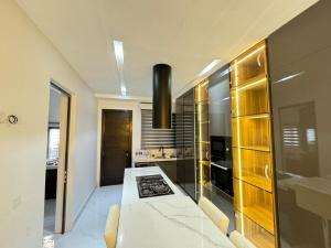 a kitchen with a stove and a counter top at Dazzling Lekki 3BR Home - Private Balcony - 247 Power, Wifi & Security in Lekki