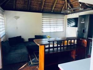 a living room with a table and a couch at Sagrada Guest House in Mthatha +11 photos