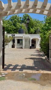 a white building with an archway in front of it at Villa Carino Kilifi Kenya in Kilifi