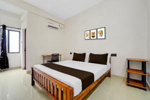 a bedroom with a large bed in a room at Hotel O Moonlight Residency in Trivandrum