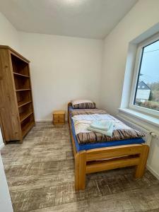a small bedroom with a bed and a window at Apartment im Grünen in Kroppach