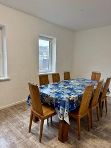a dining room table with chairs and a blue table cloth at Apartment im Grünen in Kroppach