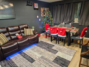 a living room with a couch and a christmas tree at Lux 2BR Condo with King Beds DTWN in Atlanta