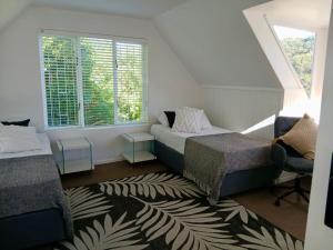 a bedroom with two beds and a window at Providence in Hermanus