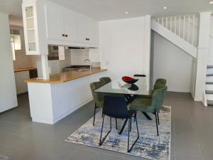 a kitchen and dining room with a table and chairs at Providence in Hermanus