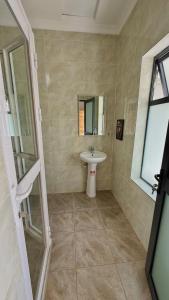 a bathroom with a sink and a mirror at Villa Carino Kilifi Kenya in Kilifi