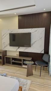 a living room with a large screen tv on a wall at Villa Carino Kilifi Kenya in Kilifi