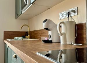 a kitchen with a white appliance sitting on a counter at Le 37 FOCH in Orange +16 photos